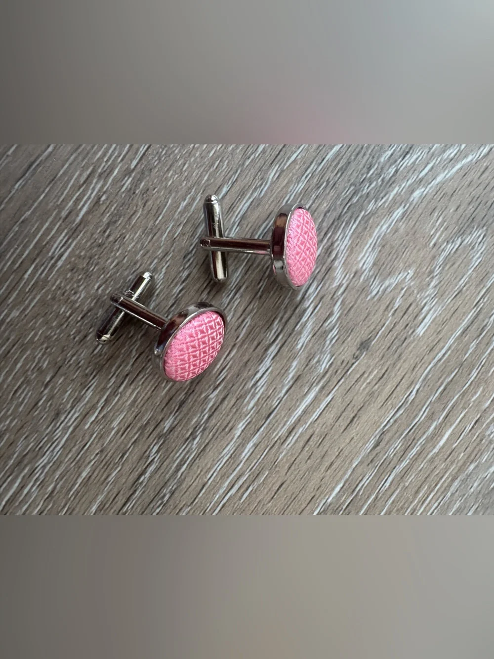 Pink textured cuff links in silver tone metal